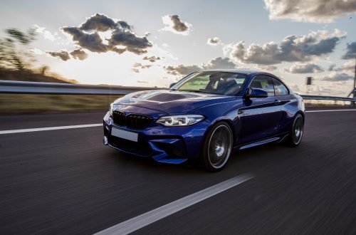 blue-sedan-car-driving-road-cloudy-weather.jpg