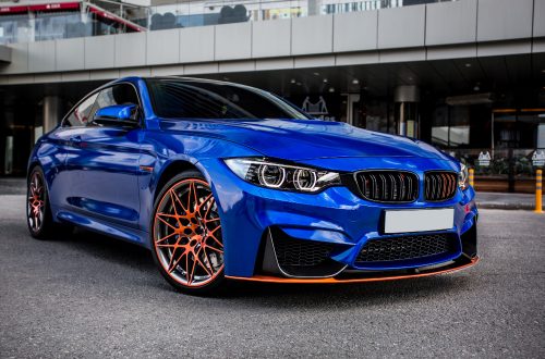 blue-sport-sedan-parked-yard.jpg