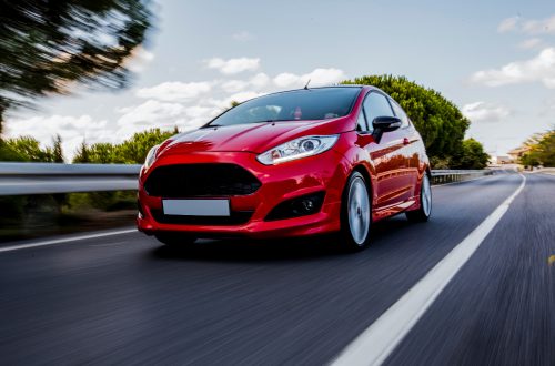 red-mini-coupe-driving-highway-with-high-speed.jpg